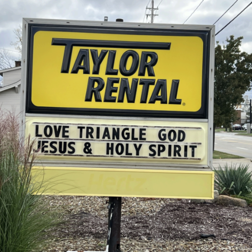 A yellow and black sign reads 